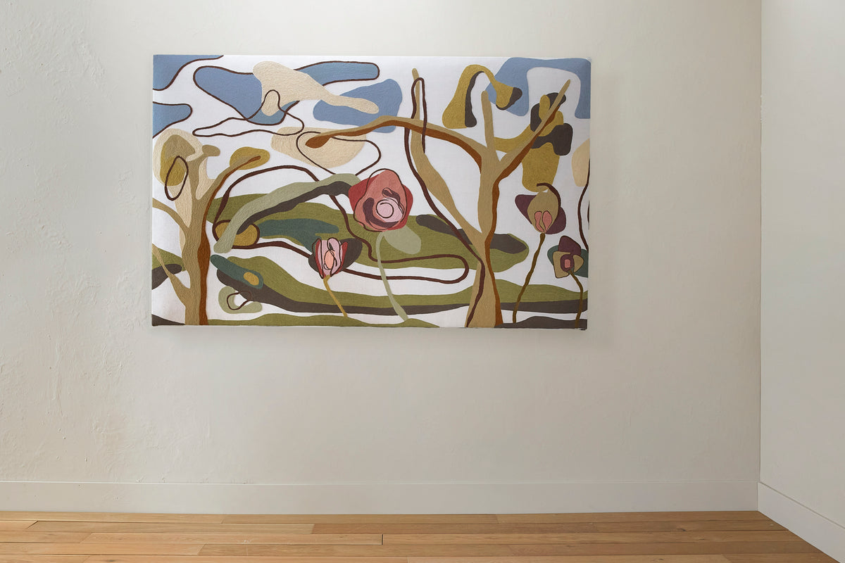 Crewel work headboard on a wall with a minimalistic room setting